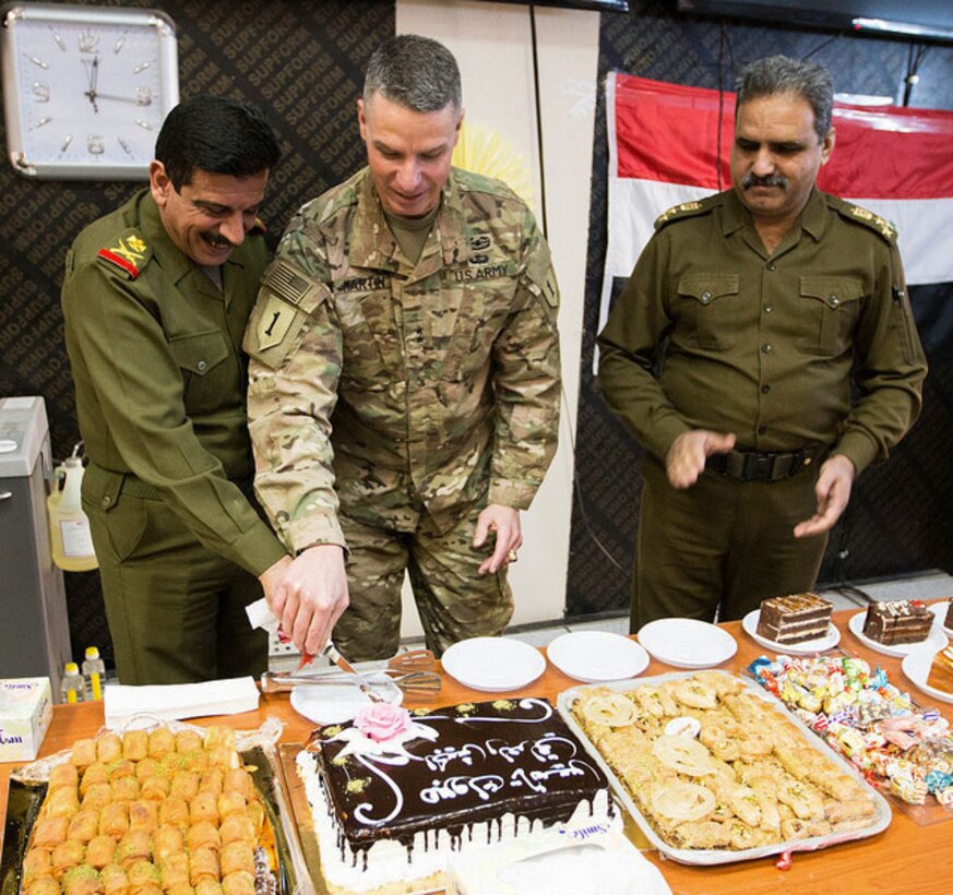 Maj. Gen. Joseph Martin, commanding general, Combined Joint Forces Land Component Command – Operation Inherent Resolve, cuts the Iraqi Armed Forces Day cake with Maj. Gen. Ahmed Abid Al-Nak Said, director, Combined Joint Operation Center – Baghdad, during a celebration Jan. 6, on Union III, Baghdad, Iraq. Iraqi Armed Forces Day commemorates the activation of the Iraqi Army on Jan. 6, 1921. (Photo by U.S. Army Spc. Derrik Tribbey)