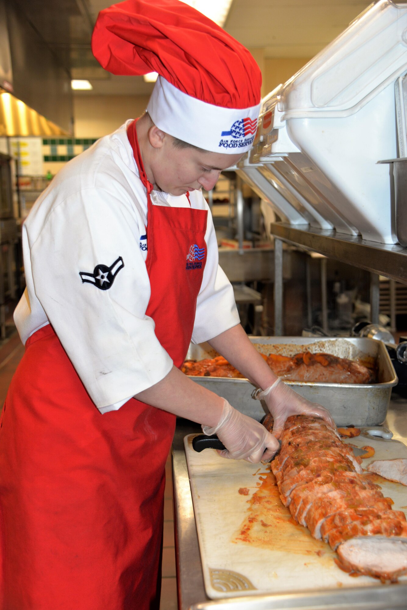 Airman Candace Ellenburg, 90th Force Support Squadron food services apprentice, prepares for lunch in Chadwell dining facility at F. E. Warren Air Force Base, Wyo., Dec. 17, 2016. Ellenburg is an eager food service Amn always willing to lend a hand and improve her culinary skills. (U.S. Air Force phot by 2nd Lt. Nikita Thorpe)