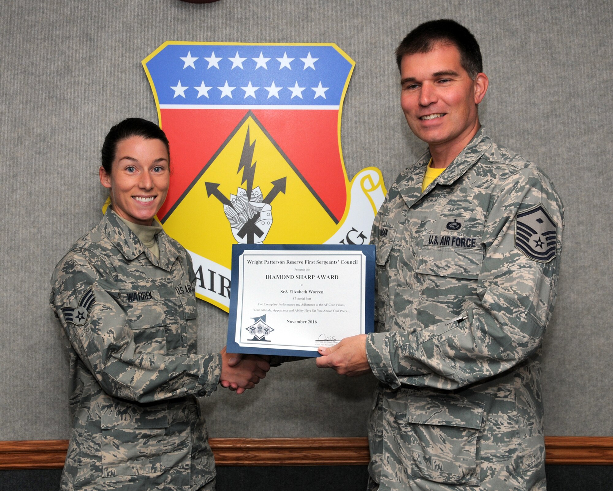 Senior Airman Elizabeth Warren, 87th Aerial Port Squadron, is presented the November 2016 Diamond Sharp award by Master Sgt. David Reagan, 445th Aeromedical Evacuation Squadron first sergeant. The award is given for exemplary performance and adherence to the Air Force Core Values, attitude and appearance. (U.S. Air Force photo /Tech. Sgt. Anthony Springer) 