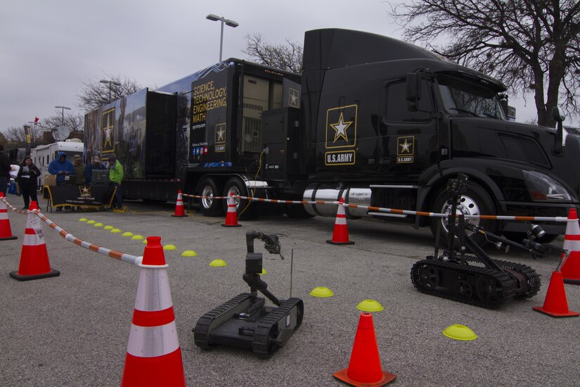 Two Army robots, controlled by students, race at the U.S. Army Mission Support Battalion Mobile Exhibit Company’s Go Army Experience outside the Alamodome in San Antonio, Jan. 6 as part of events leading up to the 2017 U.S. Army All-American Bowl (AAB). The Mobile Exhibit Company travels the country interacting with the American public to reconnect America’s people with America’s Army. The AAB will kick off Jan. 7 at the San Antonio Alamodome, and will be broadcast live on NBC at 12 p.m. CDT. (U.S. Army Reserve photo by Spc. James Lefty Larimer, 367th Mobile Public Affairs Detachment)