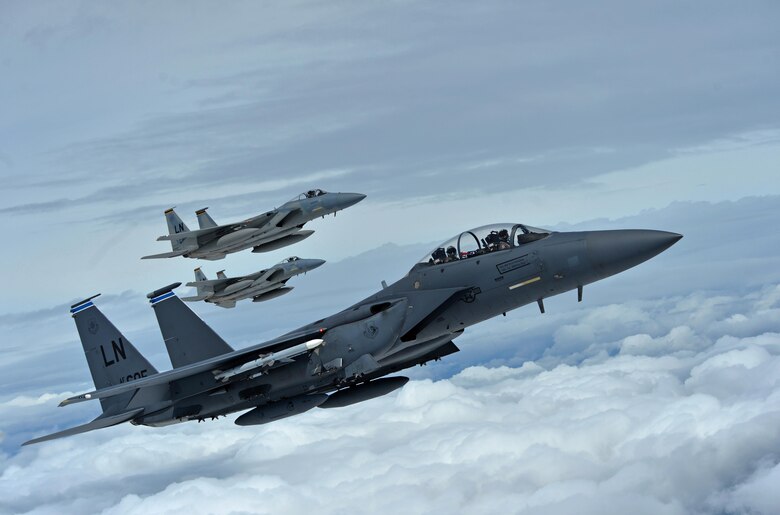 A formation of F-15C Eagles assigned to the 493rd Fighter Squadron, and an F-15E Strike Eagle assigned to the 492nd Fighter Squadron, fly over Gloucestershire, England, to attend the upcoming Royal International Air Tattoo airshow held at Royal Air Force Fairford, July 7, 2016. The Royal Air Force Lakenheath aircraft were on public display, along with many other military aircraft from around the U.K., to provide an opportunity for U.S. and military allies to showcase their capabilities. (U.S. Air Force photo/Senior Airman Erin Trower)