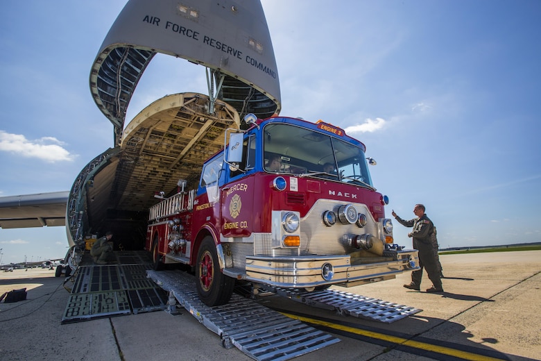 Loadmasters with the 439th Airlift Wing, Air Force Reserve Command, load a 1982 Mack 1250 GPM pumper fire truck onto a C-5B Galaxy at Joint Base McGuire-Dix-Lakehurst N.J., Aug. 12, 2016. Master Sgt. Jorge A. Narvaez, a traditional New Jersey Air National Guardsman with the 108th Security Forces Squadron, was instrumental in getting the truck donated to a group of volunteer firefighters in Managua, Nicaragua. The truck donation is done through the Denton Program, which allows U.S. citizens and organizations to use space available on military cargo aircraft to transport humanitarian goods to countries in need. (U.S. Air National Guard photo/Master Sgt. Mark C. Olsen)