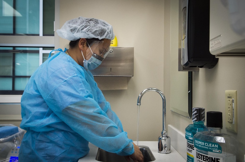 Master Sgt. Millicent Cavazos, 779th Medical Group dental squadron dental hygienist, washes her hands while preparing to perform a dental cleaning at Joint Base Andrews, Md., Jan. 6, 2017. The dental clinic now sees patients in the new edition to Malcolm Grow Medical Clinics and Surgery Center as well as their former clinic to maximize efficiency for patients. (U.S. Air Force photo by Senior Airman Mariah Haddenham)