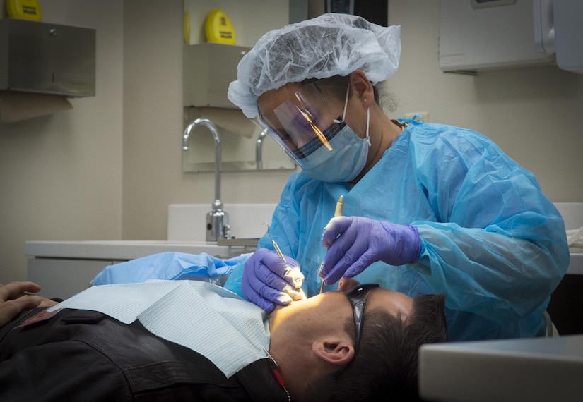 Master Sgt. Millicent Cavazos, 779th Medical Group dental squadron dental hygienist, performs a dental cleaning at Joint Base Andrews, Md., Jan. 6, 2017. The clinic, based out of the new edition to Malcolm Grow Medical Clinics and Surgery Center, sees approximately 500 patients a month. (U.S. Air Force photo by Senior Airman Mariah Haddenham)