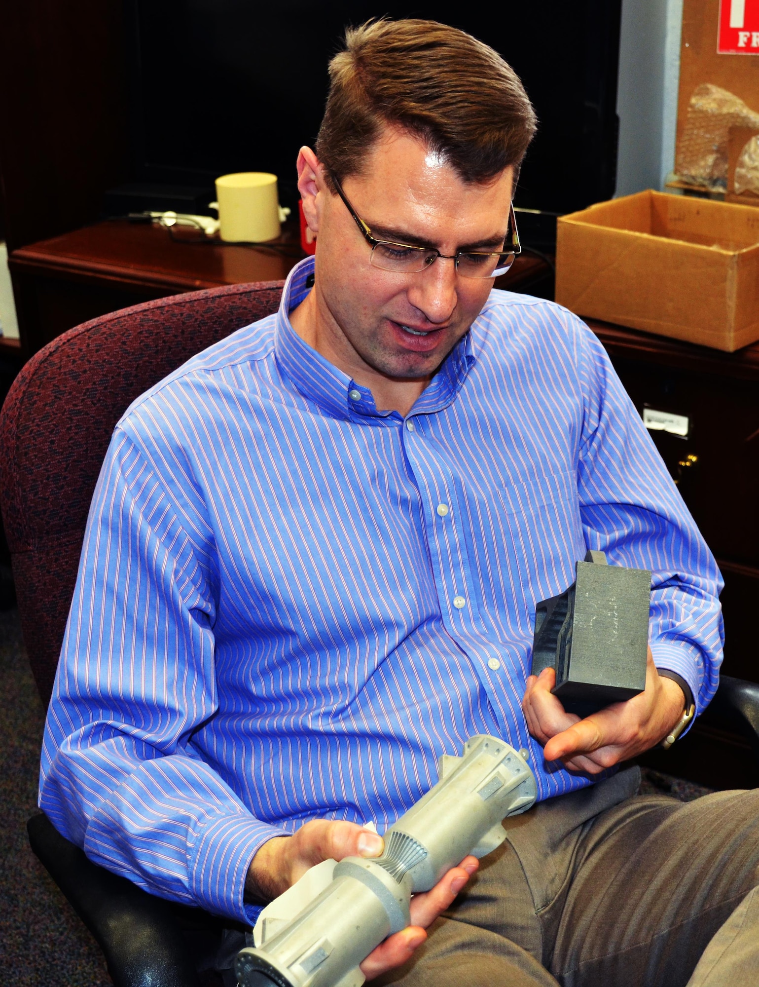 Dr. Mark Benedict, a senior materials engineer at the Air Force Research Laboratory’s Materials and Manufacturing Directorate, discusses the potential for additive manufacturing of aircraft components in metal. The complex geometry of the rocket nozzle benefits from the use of additive manufacturing due to its complex, specialized design. (U.S. Air Force photo/ Marisa Alia-Novobilski)