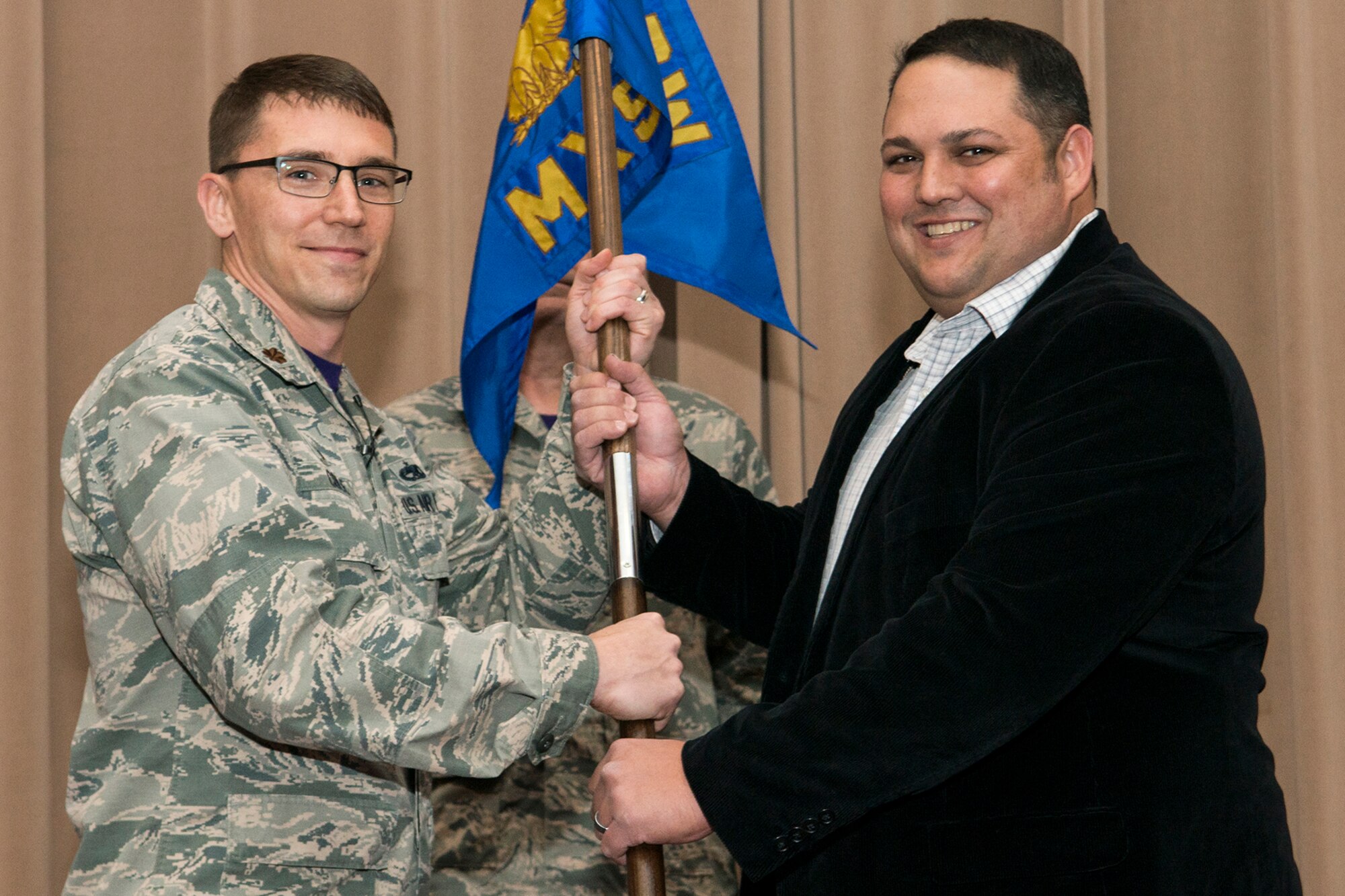 U.S. Air Force Maj. George Cole III, 307th Maintenance Squadron (MXS) commander, presents the squadron's guidon to Mr. Jack "Bump" Skaggs during a Honorary Commander's Induction Ceremony on Jan. 8, 2017, Barksdale Air Force Base, La. Skaggs was selected as the honorary commander of the 307th MXS because of his dedicated support to the 307th Bomb Wing and for being a key community leader in the Shreveport/Bossier City area. (Master Sgt. Greg Steele/Released)
