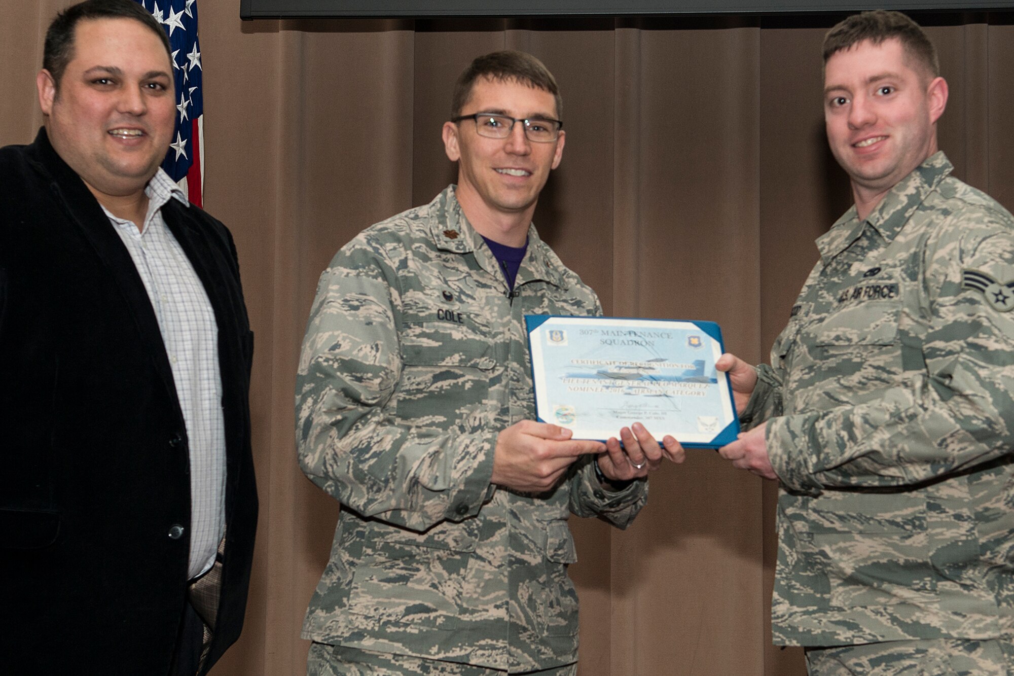 U.S. Air Force Maj. George Cole III, 307th Maintenance Squadron (MXS) commander, presents the Lt. Gen. Leo Marquez Award nominee certificate to Senior Airman Aaron Osgood on Jan. 8, 2017, Barksdale Air Force Base, La. Osgood is assigned to the 307th MXS Egress Shop and was selected to compete at the Group level for an opportunity to represent the 307th Bomb Wing at the Command level. The Award is the most prestigious maintenance award give in the United States Air Force and recognizes the best of the best in performance on the job. (Master Sgt. Greg Steele/Released)