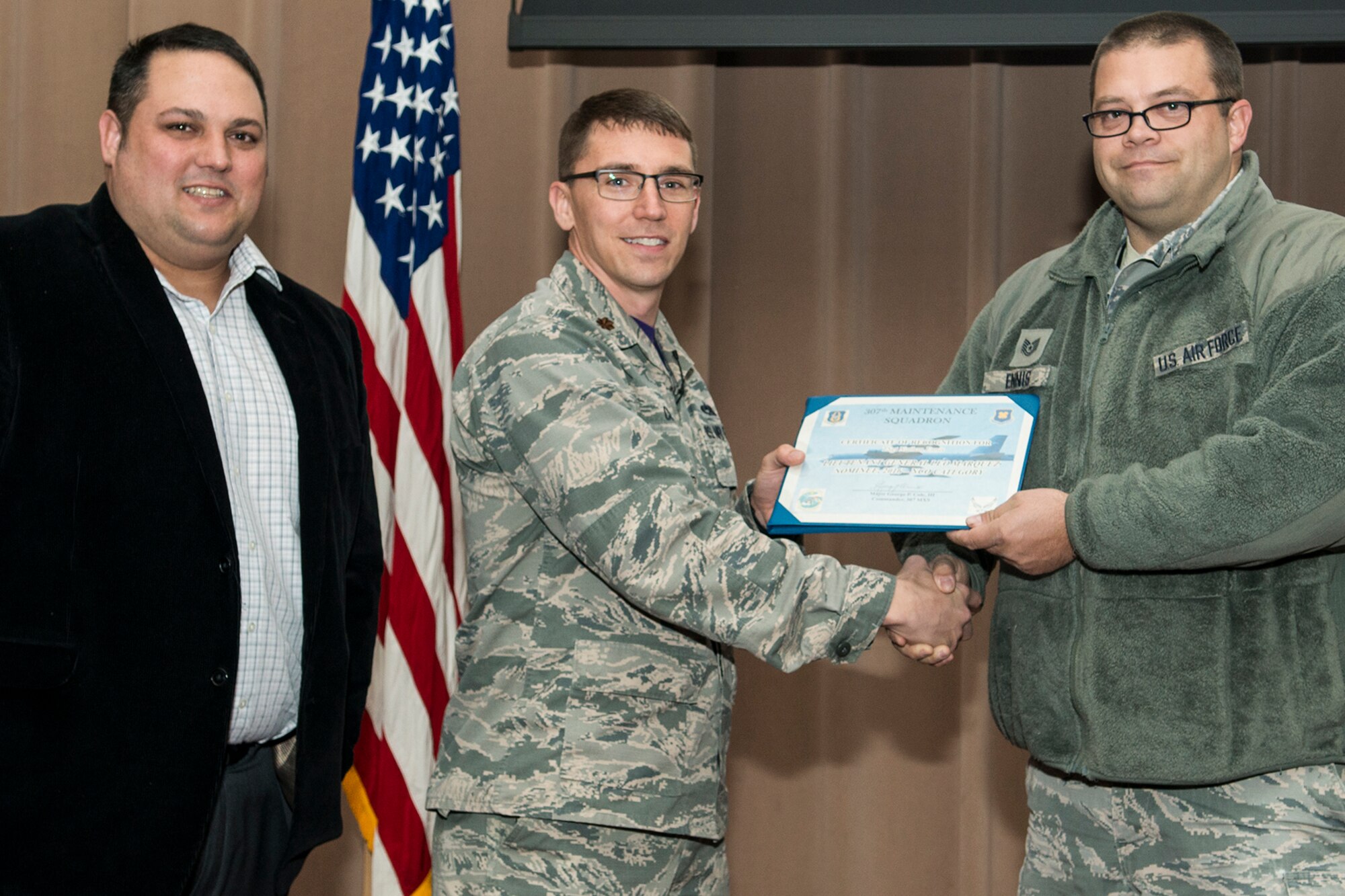 U.S. Air Force Maj. George Cole III, 307th Maintenance Squadron (MXS) commander, presents the Lt. Gen. Leo Marquez Award nominee certificate to Tech. Sgt. Nathan Ennis on Jan. 8, 2017, Barksdale Air Force Base, La. Ennis is assigned to the 307th MXS Phase Dock and was selected to compete at the Group level for an opportunity to represent the 307th Bomb Wing at the Command level. The Award is the most prestigious maintenance award give in the United States Air Force and recognizes the best of the best in performance on the job. (Master Sgt. Greg Steele/Released)