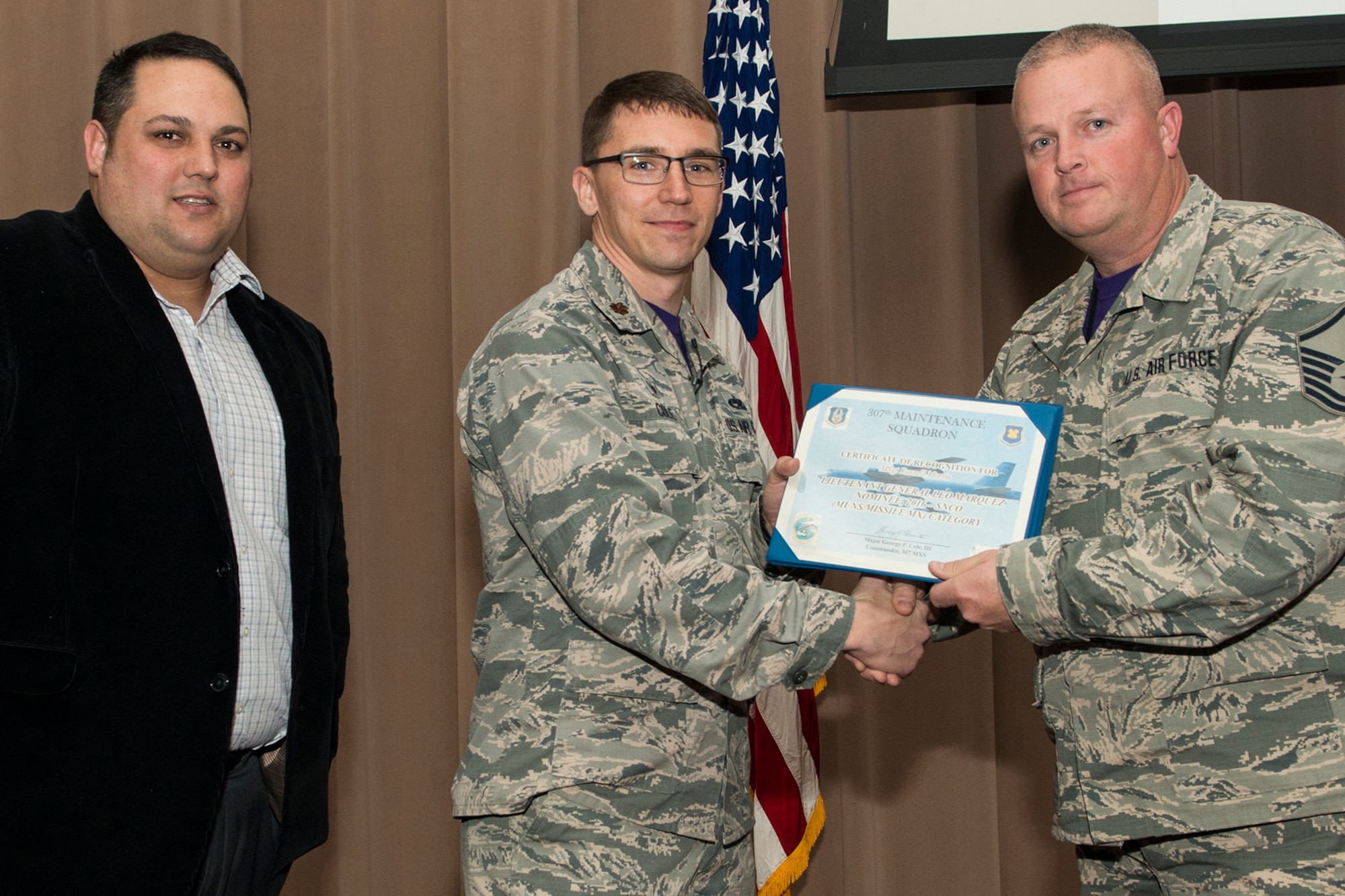U.S. Air Force Maj. George Cole III, 307th Maintenance Squadron (MXS) commander, presents the Lt. Gen. Leo Marquez Award nominee certificate to Master Sgt. Russell Morris on Jan. 8, 2017, Barksdale Air Force Base, La. Morris is assigned to the 307th MXS Munitions Flight and was selected to compete at the Group level for an opportunity to represent the 307th Bomb Wing at the Command level. The Award is the most prestigious maintenance award give in the United States Air Force and recognizes the best of the best in performance on the job. (Master Sgt. Greg Steele/Released)