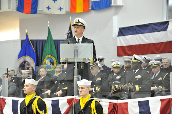 In this file photo, Chief of Naval Personnel Robert P. Burke speaks to the guests at the Pass-In-Review ceremony Dec. 16 at Midway Ceremony Drill Hall, Recruit Training Command. Burke served as the ceremony’s reviewing officer where just over 940 recruits graduated from the Navy’s only boot camp. 