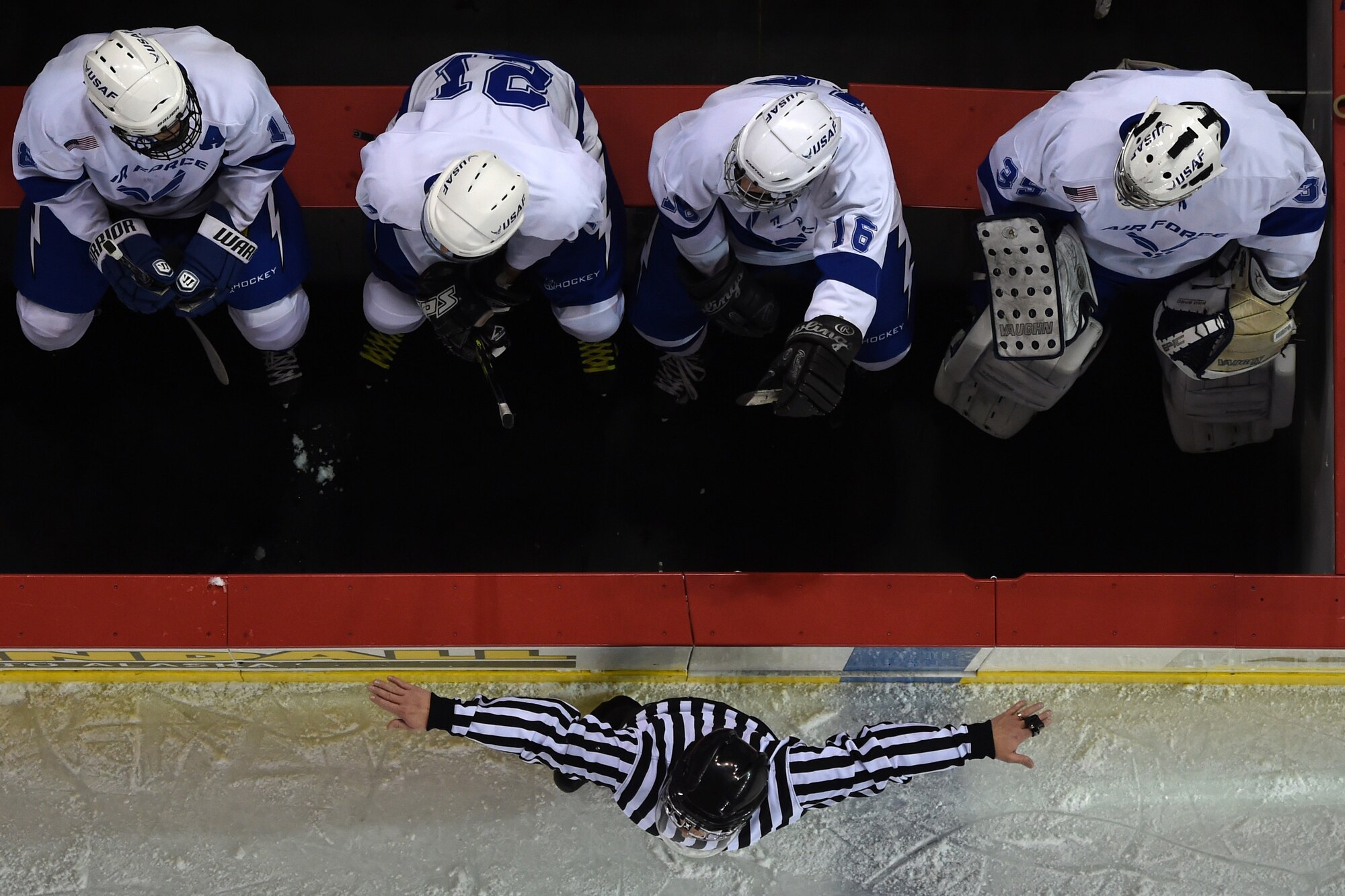 Air Force hockey team members watch from the bench as the fourth annual Army vs. Air Force Hockey game unfolds at the Sullivan Arena in Anchorage, Alaska, Jan. 7, 2017. The Army team won the match 5-0.