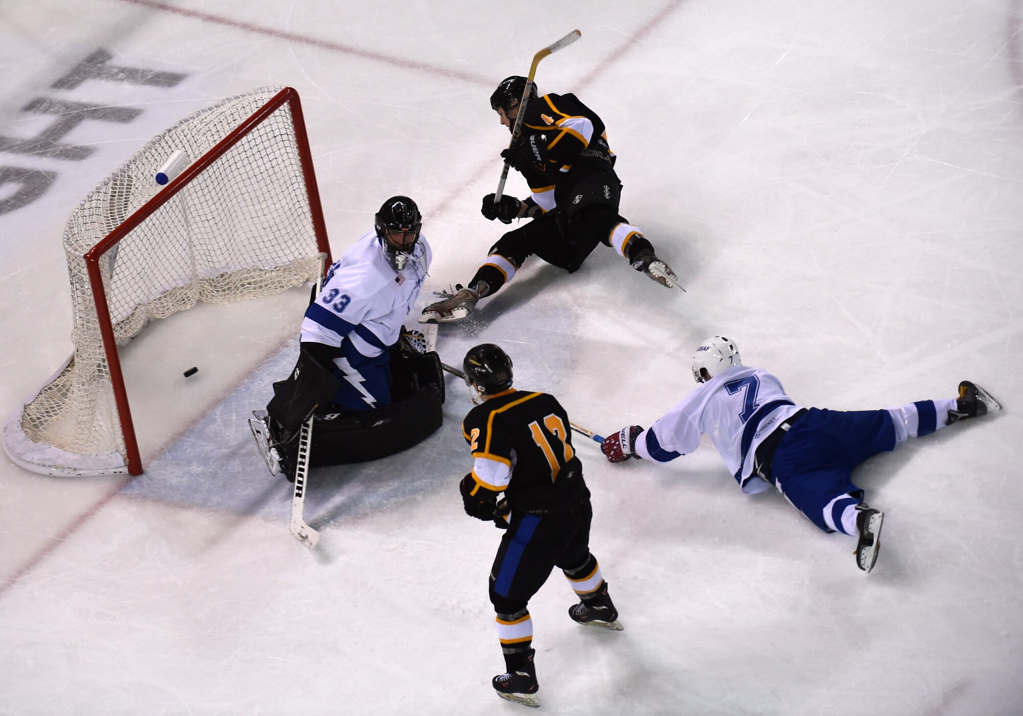 A puck slides past the Air Force team goalie at the Army vs. Air Force Hockey Game at the Sullivan Arena in Anchorage, Alaska, Jan. 7, 2017. The Army team won the match 5-0. 