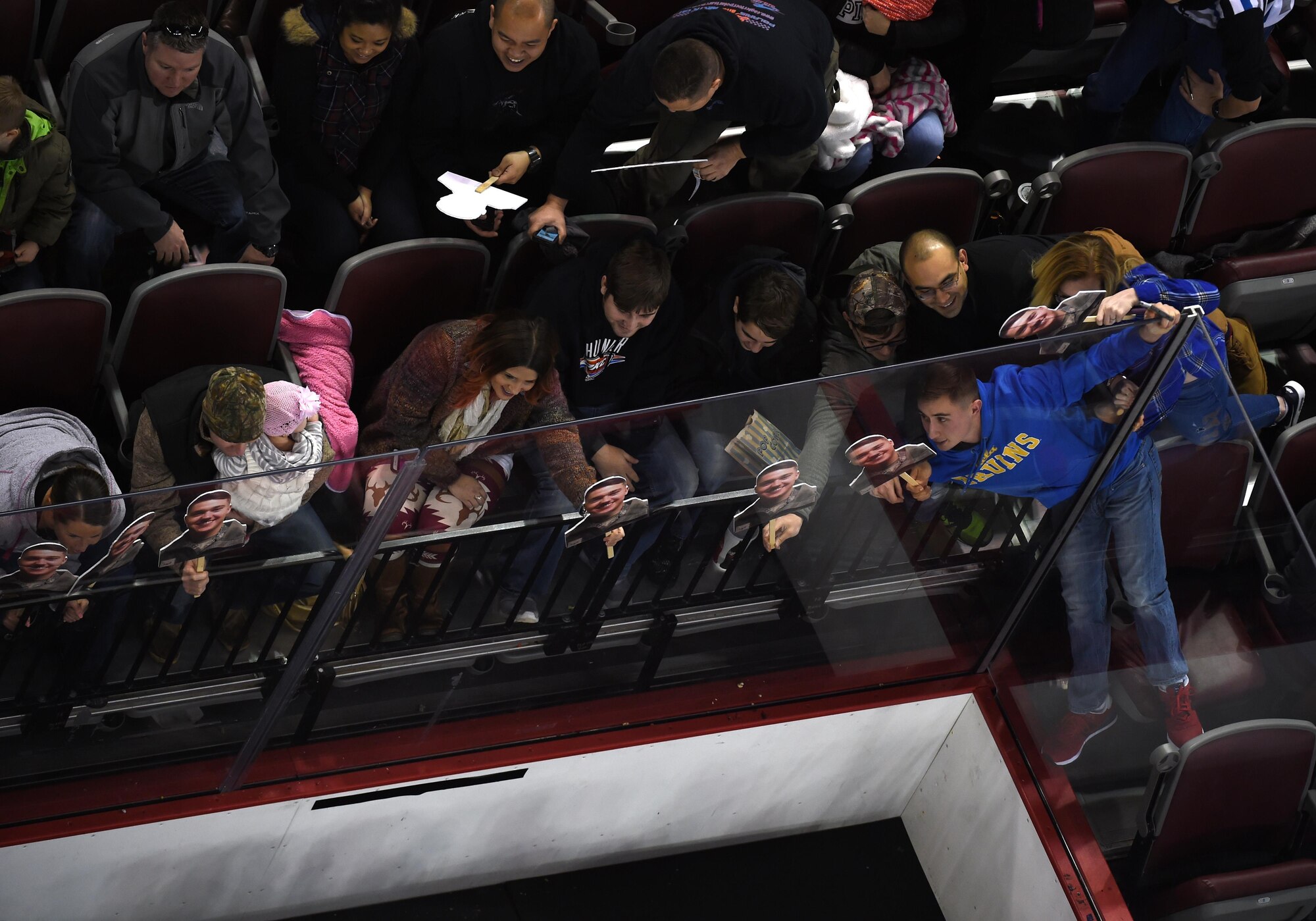 Hockey fans attempt to photobomb an Air Force team photo at the Army vs. Air Force Hockey Game at the Sullivan Arena in Anchorage, Alaska, Jan. 3, 2016. Since the Army team won the match, both teams are now evenly split for event wins.