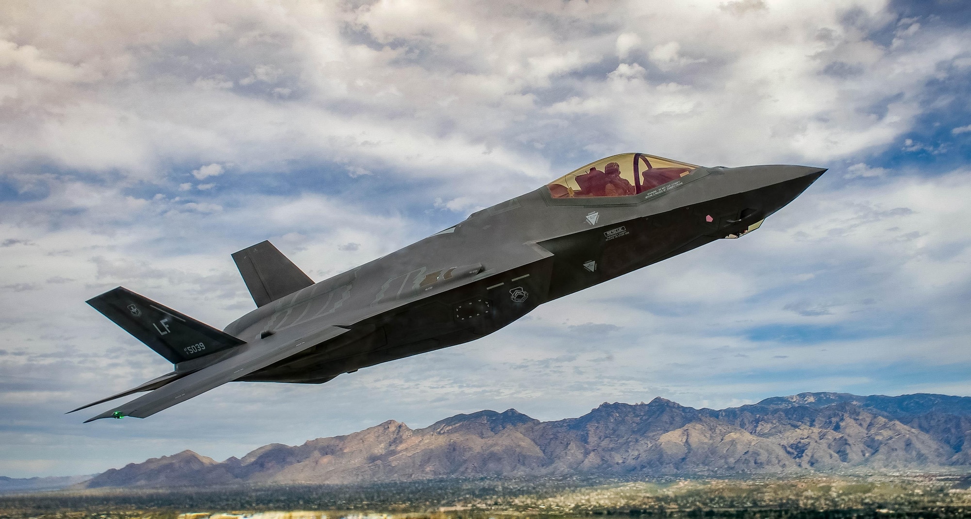 An F-35 Lightning II flies around the airspace of Davis-Monthan Air Force Base, Ariz., March 5, 2016. The F-35 was participating in Air Combat Command’s Heritage Flight Training Course, a program that features modern fighter and attack aircraft flying alongside Word War II, Korean War and Vietnam War-era aircraft. (U.S. Air Force photo/Tech. Sgt. Brandon Shapiro)
