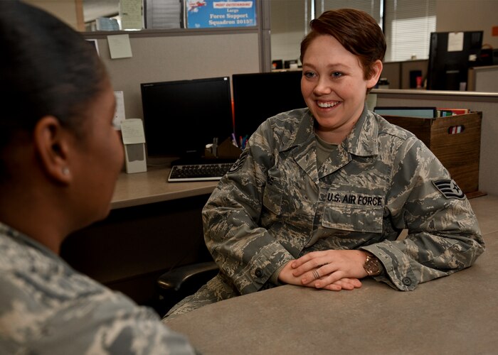 PETERSON AIR FORCE BASE, Colo. – Staff Sgt. Jacquelyn Combs, 21st Force Support Squadron NCO in charge of customer support at the Military Personnel Section, jokes with a coworker at the Military Personnel Section on Peterson Air Force Base, Colo., Nov. 14, 2016. Combs was diagnosed with Crohn’s disease while at her first base and diagnosed with cancer at her second base, but didn’t let either of them stop her from doing her best. (U.S. Air Force photo by Senior Airman Rose Gudex)