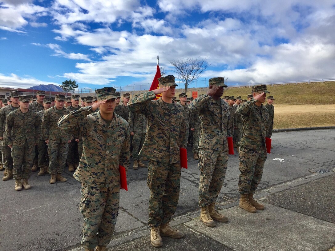 Four U.S. Marines receive Navy Achievement Medals during a battalion formation Jan. 9, 2017, aboard Combined Arms Training Center Camp Fuji, Japan, for their instinctive response when a vehicle with five passengers fell from the fifth story of a parking garage in Yokosuka, a city in the Greater Tokyo Area, Dec. 31, 2016. Once the Marines arrived on scene, the group flipped the car in order to remove the passengers prior to Japanese Emergency Medical Services arriving. The Marines are riflemen assigned to 3rd Battalion, 1st Marine Regiment and forward-deployed to 3rd Marine Division, III Marine Expeditionary Force, based in Okinawa, Japan. U.S. Marines pictured left to right: Lance Cpl. Manaure Arellano, Lance Cpl. James Flores, Lance Cpl. Raheem Gilliam and Pfc. Jacob Boerner. (U.S. Marine Corps photo by Sgt. Maj. Damien Coan)