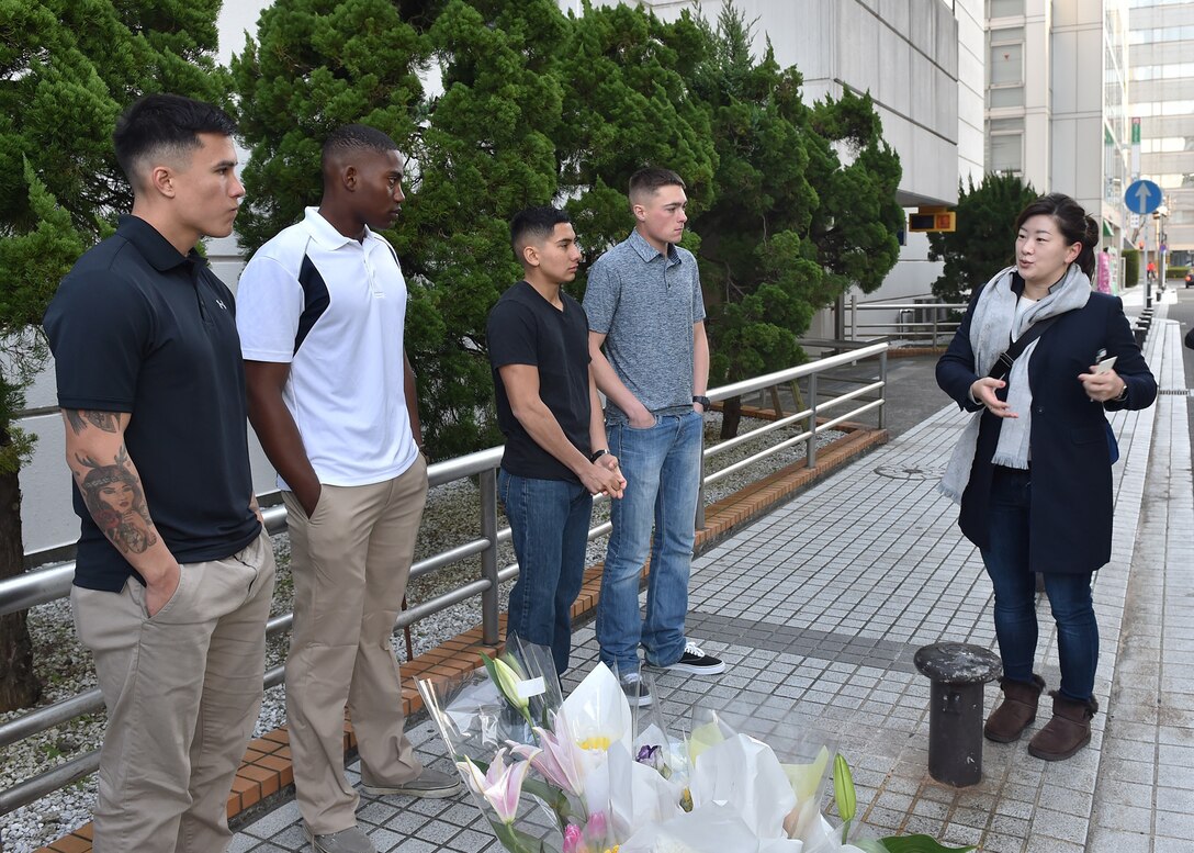 A reporter with Kyodo News interviews U.S. Marines and Sailors in downtown Yokosuka, Japan, Jan. 7, 2016. Four U.S. Marines and two Sailors instinctively responded alongside local residents when a vehicle with five passengers fell from the fifth story of a parking garage in Yokosuka, Dec. 31, 2016. Once the Marines arrived on scene, the group collectively flipped the car in order to remove the passengers prior to Japanese Emergency Medical Services arriving. The Marines are assigned to 3rd Battalion, 1st Marine Regiment and forward deployed to 3rd Marine Division, III Marine Expeditionary Force based in Okinawa, Japan. The Sailors are assigned to Commander Fleet Activities Yokosuka. U.S. Marines pictured left to right at the memorial sight of the accident: Pfc. Jacob Boerner, Lance Cpl. Raheem Gilliam, Lance Cpl. Manaure Arellano and Lance Cpl. James Flores. (U.S. Navy photo by Petty Officer 2nd Class Richard Gourley)
