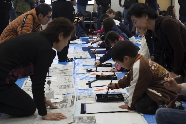 Children from Marine Corps Air Station Iwakuni and Japanese local children practice calligraphy with the help of instructors in Waki Town, Japan, Jan. 7, 2017.  The children learned how to write their goals in Kanji for the new year. Similar to the American tradition of New Year’s resolutions, the Japanese use calligraphy to write their goals at the beginning of every new year.   (U.S. Marine Corps photo by Lance Cpl. Joseph Abrego)