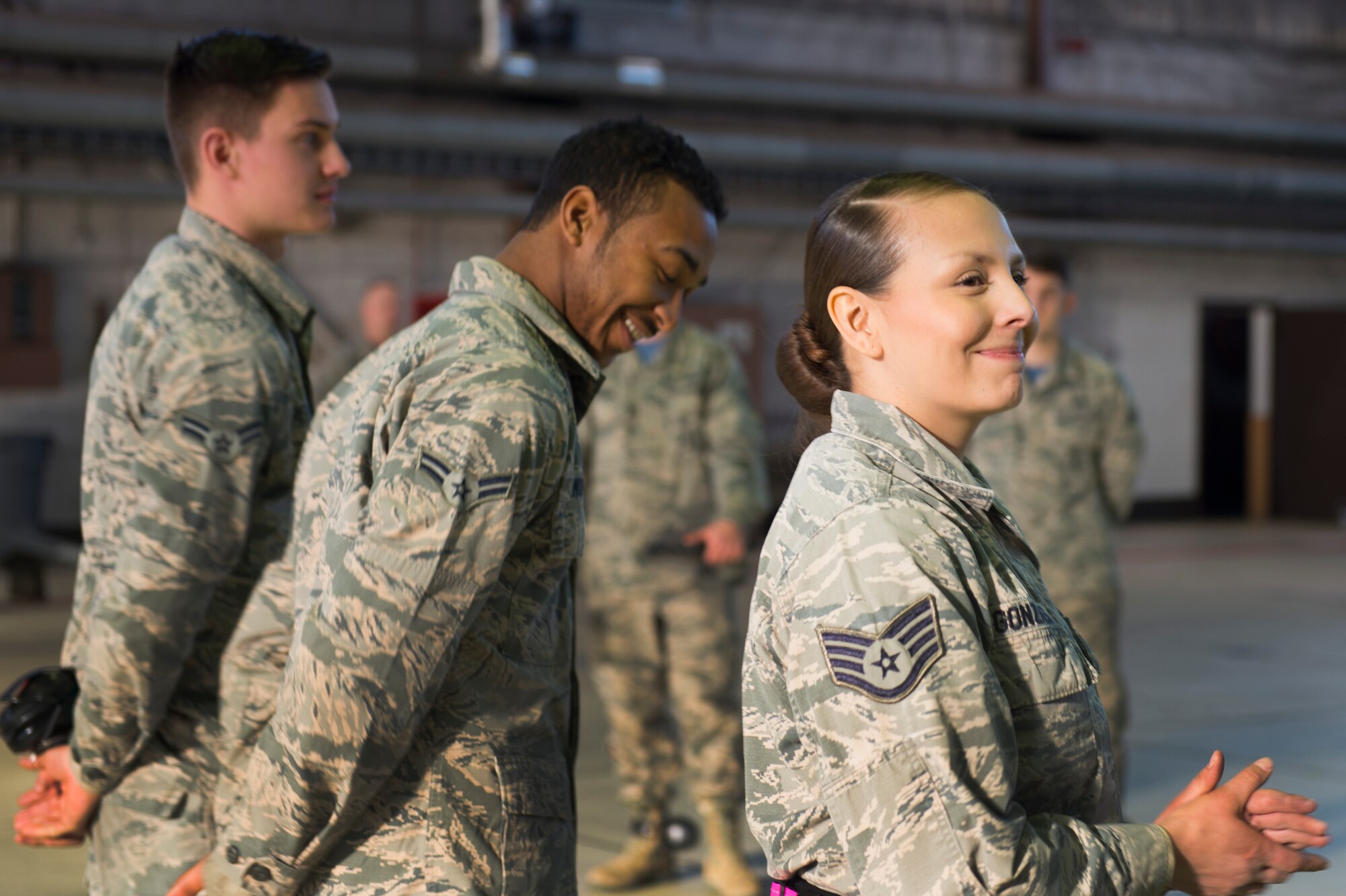 U.S. Air Force Staff Sgt. Sarah Gonzales, Airmen 1st Class Licinio Monteiro and Joshua Reeves, all 52nd Aircraft Maintenance Squadron tactical aircraft weapons systems specialists are announced as the winners of the 52nd Fighter Wing Load Crew of the Quarter competition at Spangdahlem Air Base, Germany, Jan. 6, 2017. Gonzales and her team will compete in the Load Crew of the Year competition against previous quarterly competition winners, Friday, Jan. 13, 2017. (U.S. Air Force photo by Senior Airman Dawn M. Weber)