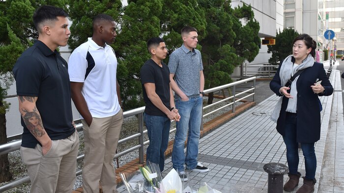 A reporter with Kyodo News interviews U.S. Marines and Sailors in downtown Yokosuka, Japan, Jan. 7, 2017. Four U.S. Marines and two Sailors instinctively responded alongside local residents when a vehicle with five passengers fell from the fifth story of a parking garage in Yokosuka, Dec. 31, 2016. Once the Marines arrived on scene, the group collectively flipped the car in order to remove the passengers prior to Japanese Emergency Medical Services arriving. The Marines are assigned to 3rd Battalion, 1st Marine Regiment and forward deployed to 3rd Marine Division, III Marine Expeditionary Force based in Okinawa, Japan. The Sailors are assigned to Commander Fleet Activities Yokosuka. U.S. Marines pictured left to right at the memorial sight of the accident: Pfc. Jacob Boerner, Lance Cpl. Raheem Gilliam, Lance Cpl. Manaure Arellano and Lance Cpl. James Flores.
