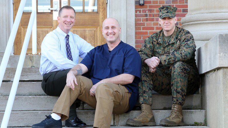 Joseph Klocek (left) and Maj. Scott Graniero (right) pose with Master Sgt. Clifford Farmer at Marine Corps Systems Command aboard Marine Corps Base Quantico, Va. Farmer credits the support and compassion of the two men—part of his leadership team at MCSC—with saving his life during a time when he contemplated suicide. Today, Farmer battles post-traumatic stress disorder and depression, and urges leaders across the Marine Corps to show understanding and compassion for Marines who may be suffering.