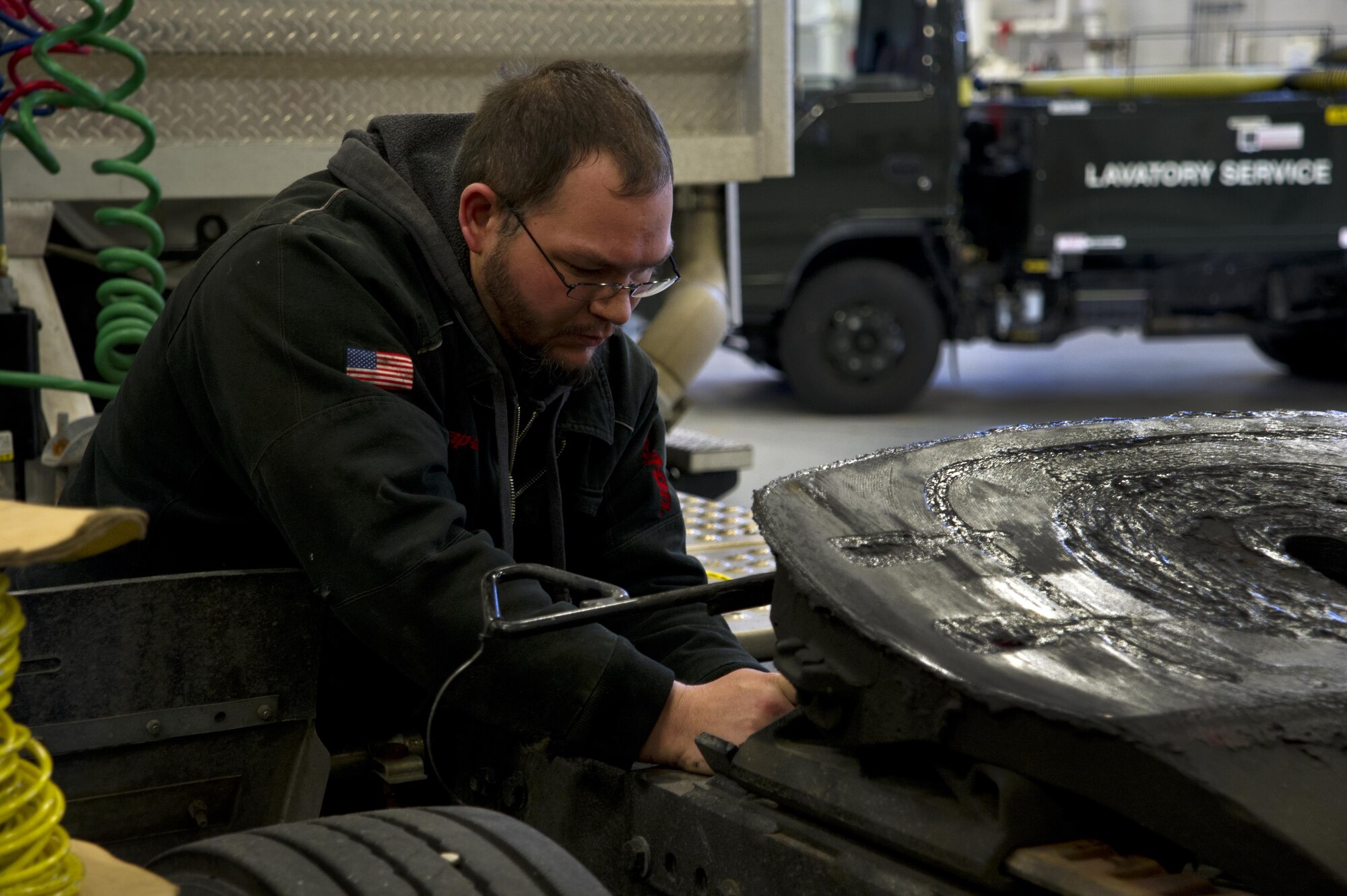 Josh Siler, Data Monitor Systems mechanic, inspects a faulty brake line on a truck at Grissom Air Reserve Base, Ind., Jan. 4, 2017. Siler is the heavy equipment specialist at DMS, and is tasked with repairing many of the largest vehicles in the fleet. (U.S. Air Force photo/Senior Airman Harrison Withrow)