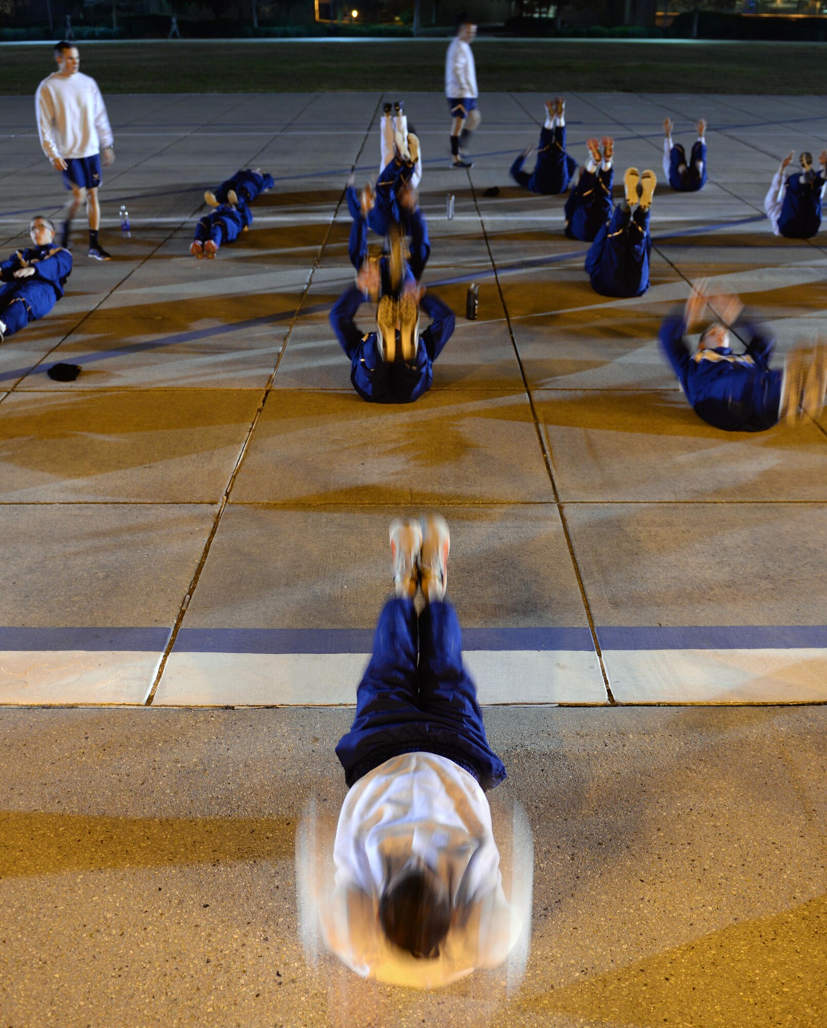 A student from the 81st Training Support Squadron Military Training Leader Course leads non-prior service Airmen during a physical training evaluation at the Levitow Training Support Facility drill pad, Dec. 21, 2016, on Keesler Air Force Base, Miss. MTL Course instructors evaluated students on their ability to lead a PT session with NPS Airmen and tested them in a variety of different areas during the four-week course, including drill and ceremony, dress and appearance, mentorship, counseling and room inspections. (U.S. Air Force photo by Senior Airman Duncan McElroy)