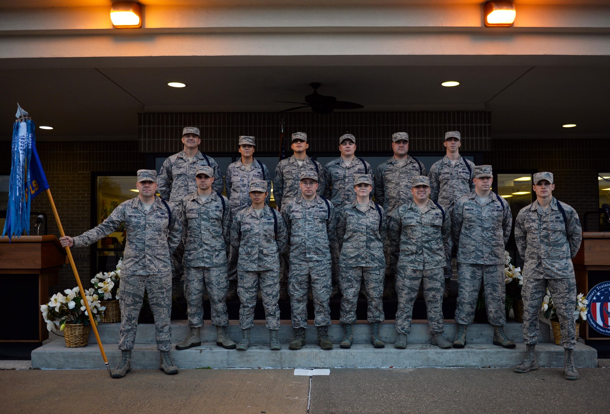 NCOs attending the 81st Training Support Squadron Military Training Leader Course pose for a photo with their instructors following their graduation ceremony at the Levitow Training Support Facility, Dec. 22, 2016, on Keesler Air Force Base, Miss. Twelve NCOs received their blue aiguillettes and will be assigned to different training groups within 2nd AF to mentor, train and lead non-prior service Airmen. (U.S. Air Force photo by Senior Airman Duncan McElroy)