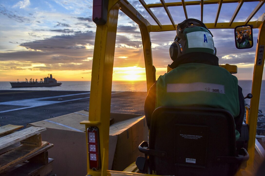 Navy Petty Officer 1st Class Victor Duran waits in a forklift as the aircraft carrier USS Carl Vinson prepares to conduct a vertical replenishment with the fleet replenishment oiler USNS Yukon in the Pacific Ocean, Jan. 7, 2017. Duran is a logistics specialist. Navy photo by Petty Officer 2nd Class Sean M. Castellano
