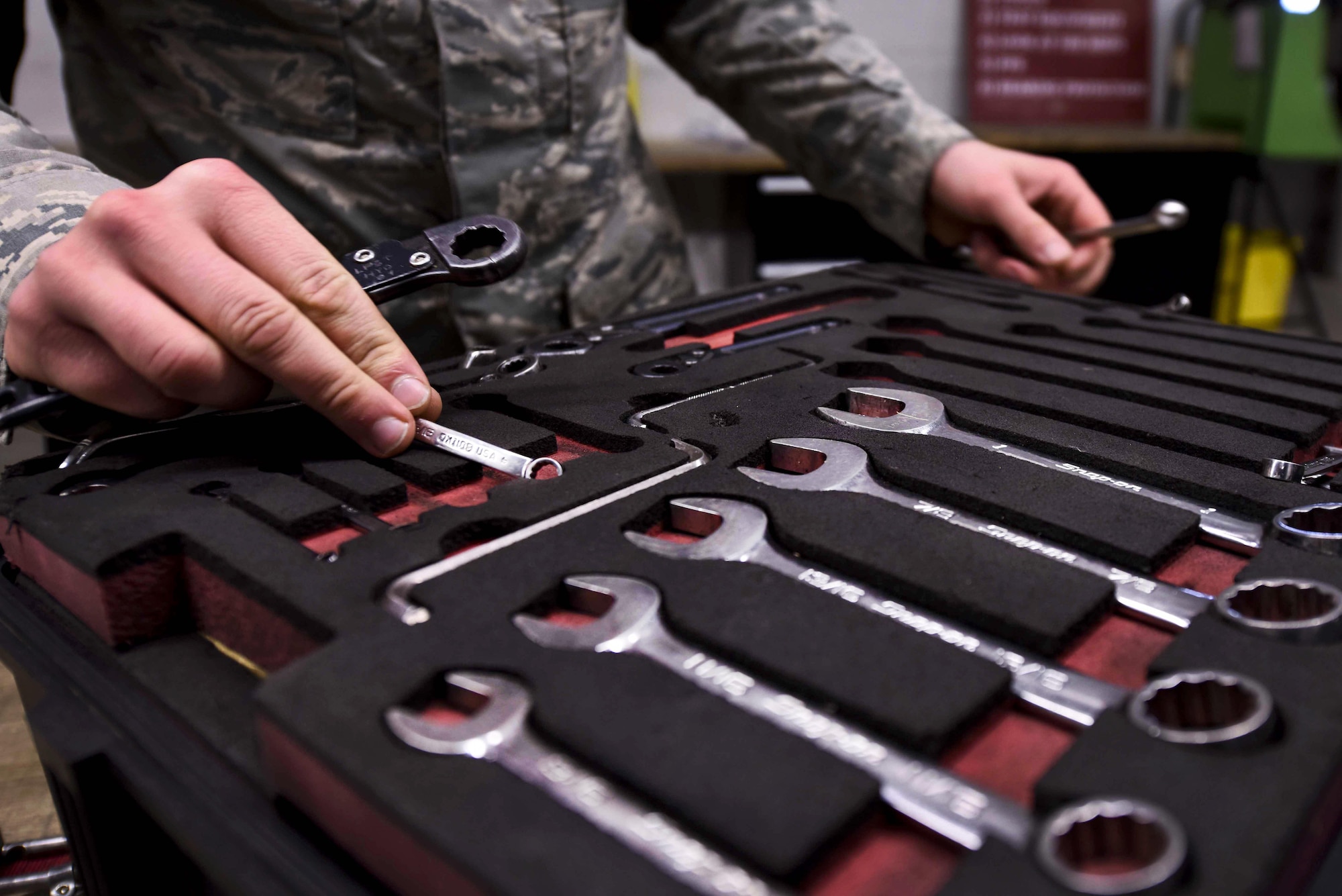U.S. Air Force Airman 1st Class Matthew Weller, 19th Aircraft Maintenance Squadron hydraulics journeyman, examines tools before checking them out of the Composite Tool Kit shop Jan. 4, 2017, at Little Rock Air Force Base, Ark. Each tool, part or piece of equipment located at CTK is kept ready to assist maintainers in executing the mission. (U.S. Air Force photo by Senior Airman Stephanie Serrano)