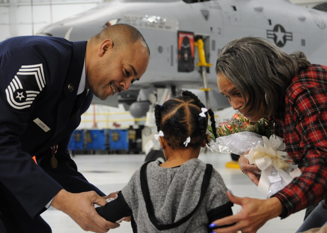U.S. Air Force Chief Master Sgt. Kellie Askew, 442d Aircraft Maintenance Squadron deputy superintendent, presents his mother and granddaughter flowers during his promotion ceremony at Whiteman Air Force Base, Missouri, Jan. 7, 2017. Askew left active-duty in 1996 and joined the Air Force Reserve unit at Hill AFB, Utah. (U.S. Air Force photo/Senior Airman Missy Sterling)