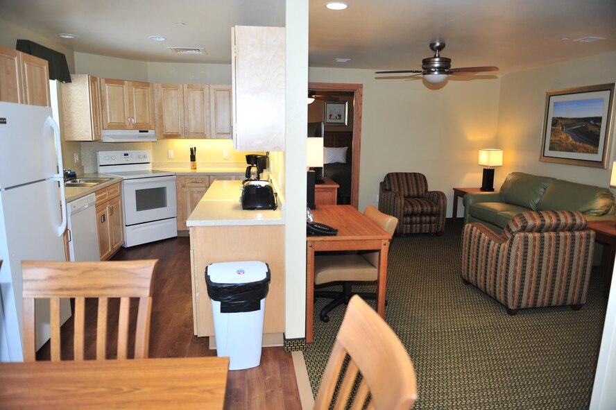 A kitchen and living room from one of the new Temporary Lodging Facility units are displayed at Minot Air Force Base, N.D., Jan. 6, 2017. Each of the 30 units have two bedrooms, a full kitchen, and a washer and dryer to serve Air Force families moving to and from Minot AFB. (U.S. Air Force photo/Senior Airman Apryl Hall)