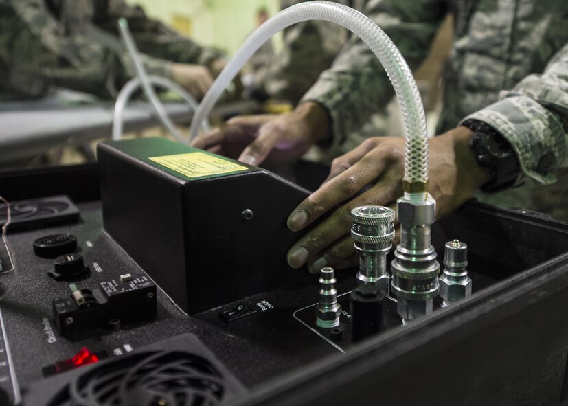 Senior Airman Devon Guillory, a 49th Maintenance Squadron aircraft structural maintenance technician, adjusts the temperature on a hot bonder, Dec. 14, 2016, at Holloman Air Force Base, N.M. The hot bonder adjusts the temperature for vacuum repairs on composite structures. Once the composite structure is repaired, it can be sanded, painted and returned to the aircraft. (U.S. Air Force photo by Senior Airman Emily Kenney)