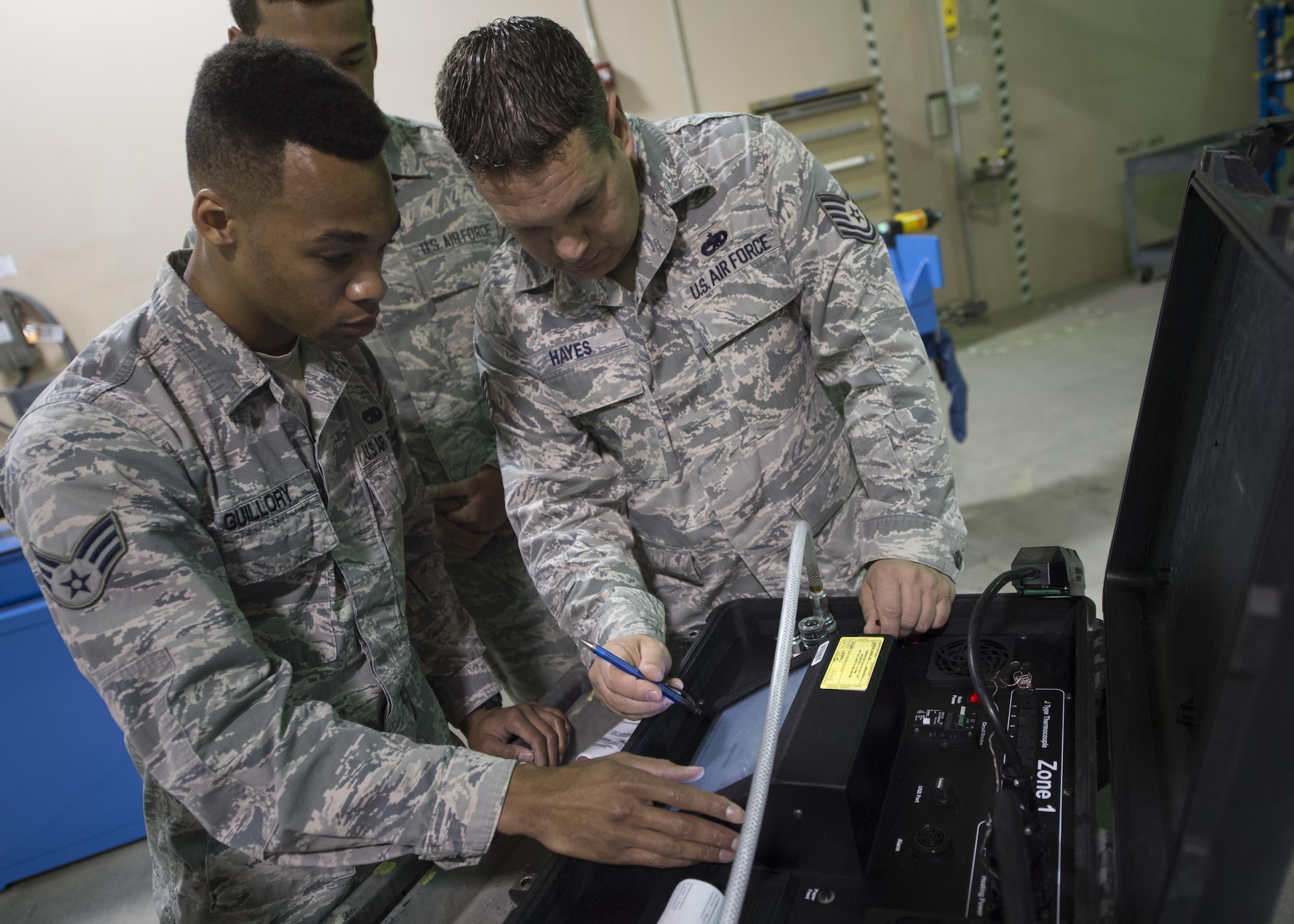 Senior Airman Devon Guillory and Tech. Sgt. Adam Hayes, 49th Maintenance Squadron aircraft structural maintenance technicians, analyze readings on a hot bonder, Dec. 14, 2016, at Holloman Air Force Base, N.M. The hot bonder adjusts the temperature for vacuum repairs on composite structures. Once the composite structure is repaired, it can be sanded, painted and returned to the aircraft. (U.S. Air Force photo by Senior Airman Emily Kenney) 