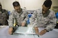 Senior Airman Devon Guillory and Tech. Sgt. Adam Hayes, 49th Maintenance Squadron aircraft structural maintenance technicians, create a seal on a vacuum repair on a composite structure Dec. 14, 2016, at Holloman Air Force Base, N.M. Once the composite structure is repaired, it can be sanded, painted and returned to the aircraft. (U.S. Air Force photo/Senior Airman Emily Kenney)