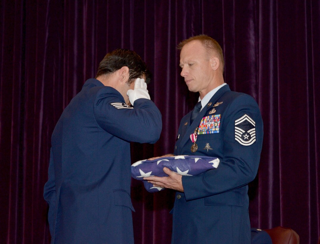 Lt. Col. Chad Senior, deputy commander, Cadet Group Four,
U.S. Air Force Academy, presided over SMSgt. Jon Grant's retirement, January 7, 2017 at Patrick Air Force Base, Florida. During the retirement Jon's wife was honored with a certificate of appreciation for her support to the military and Jon's 27-year Air Force career as a pararescueman. Many wing comrades and commanders filled the room to honor the Grants for their longstanding service to country. (U.S. Air Force photo/Senior Airman Brandon Kalloo Sanes)