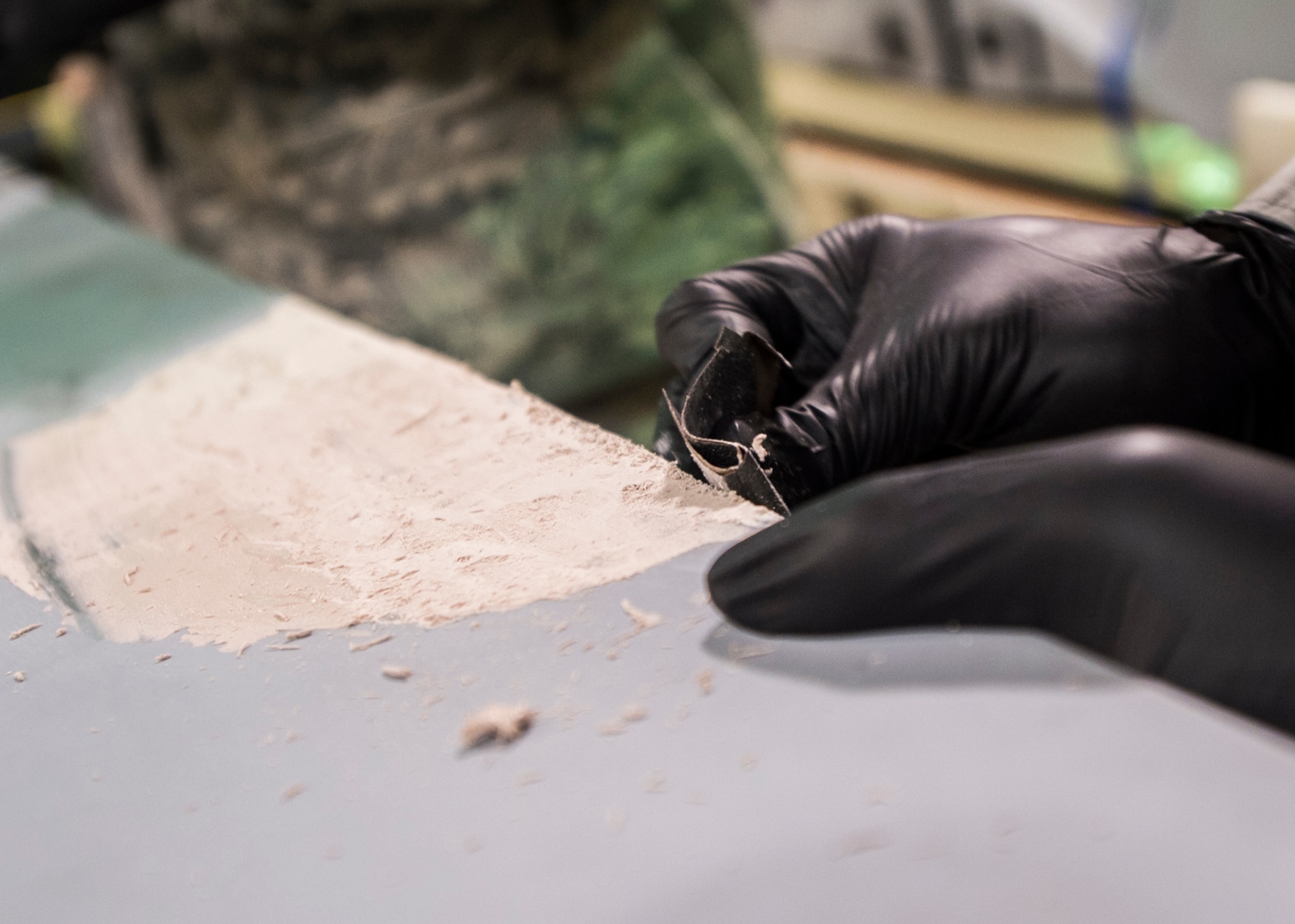 Airman 1st Class Joshua Guthrie, a 49th Maintenance Squadron aircraft structural maintenance technician, sands aircraft smoothing compound to match the contour of an MQ-1 Predator wing, Dec. 14, 2016, at Holloman Air Force Base, N.M. The sheet metal shop has been prepping an MQ-1 Predator static display for Heritage Park, pending the Predator’s retirement in early 2017. (U.S. Air Force photo by Senior Airman Emily Kenney)