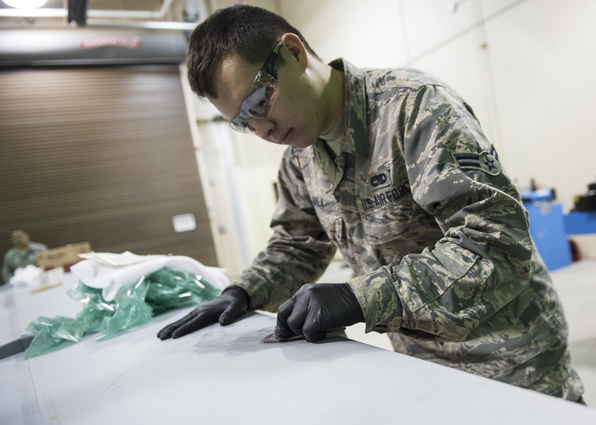 Airman 1st Class Nathaniel Avila, a 49th Maintenance Squadron aircraft structural maintenance technician, sands down a composite structural repair, Dec. 14, 2016, at Holloman Air Force Base, N.M. Structural maintenance technicians primarily do back shop repairs and flight line jobs for both F-16 Fighting Falcons and MQ-9 Reapers. They also re-manufacture parts that are no longer available for purchase. (U.S. Air Force photo by Senior Airman Emily Kenney)