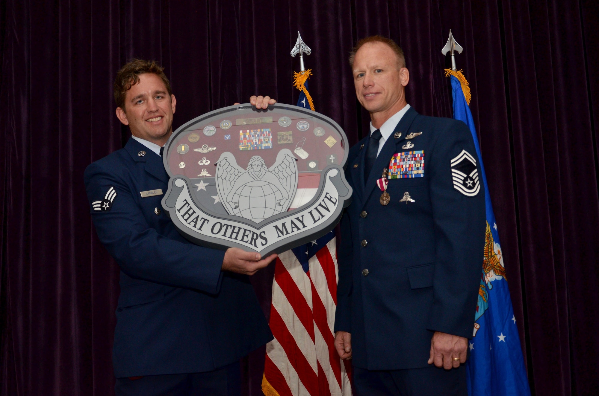 Members of the 308th Rescue Squadron presented Senior Master Sgt. Jon Grant, pararescue superintendent, 920th Operations Group, with a special shadow box for his retirement from the Air Force Reserve January 7, 2017, after 27-year Air Force career as a pararescueman. During the ceremony at Patrick Air Force Base, comrades and commanders filled the room to honor him and his family for their longstanding service to country. (U.S. Air Force photo/Senior Airman Brandon Kalloo Sanes)