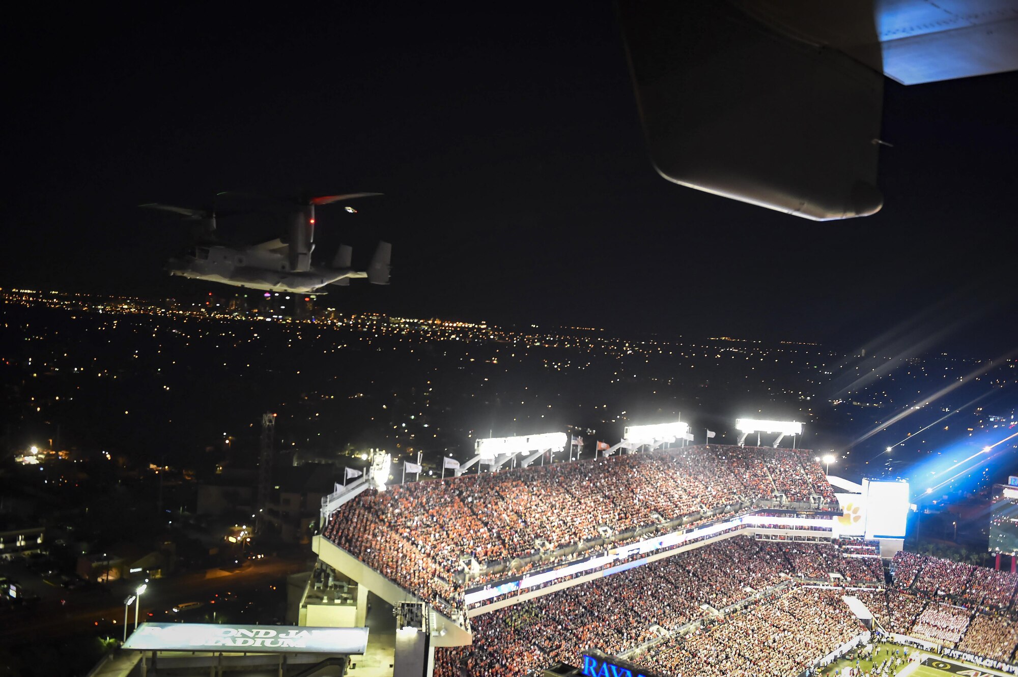 A CV-22 Osprey tiltrotor aircraft assigned to the 1st Special Operations Wing performs a flyover during the 2017 College Football Playoff National Championship game at Raymond James Stadium in Tampa, Fla., Jan. 9, 2017. The flyover was performed by two Ospreys and occurred during the playing of the National Anthem. (U.S. Air Force photo by Staff Sgt. Christopher Callaway)
