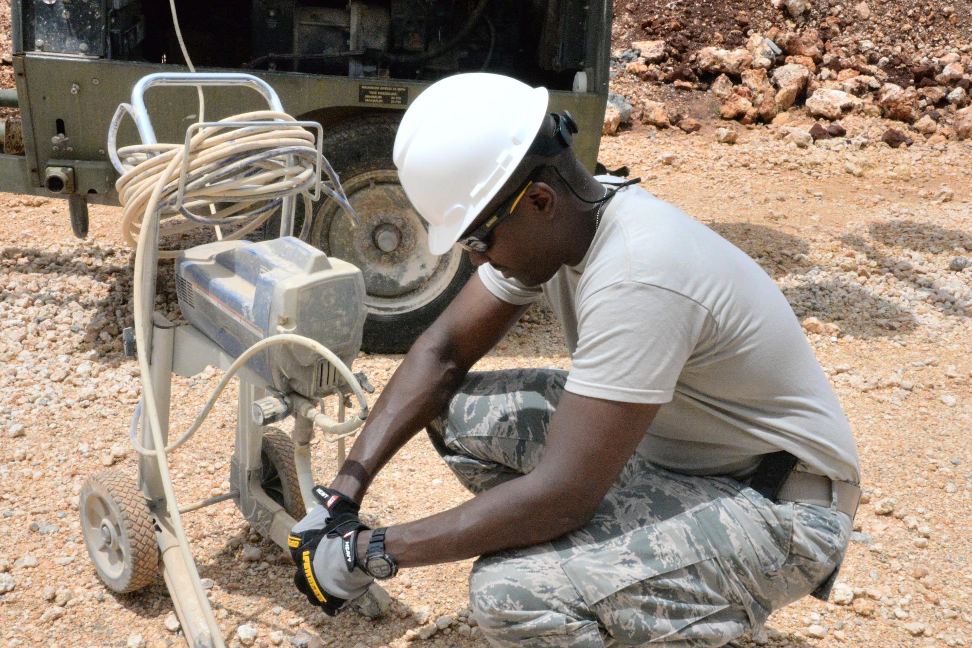 U.S. Air Force Airman assigned to the 181st Intelligence Wing Civil Engineering Squadron prepares a paint sprayer for use during his annual training at Andersen AFB, Guam, July 13, 2016. The 181st engineers provided contingency related hands-on training for Air National Guard CE Airmen. (U.S. Air National Guard photo by Senior Airman Lonnie Wiram)