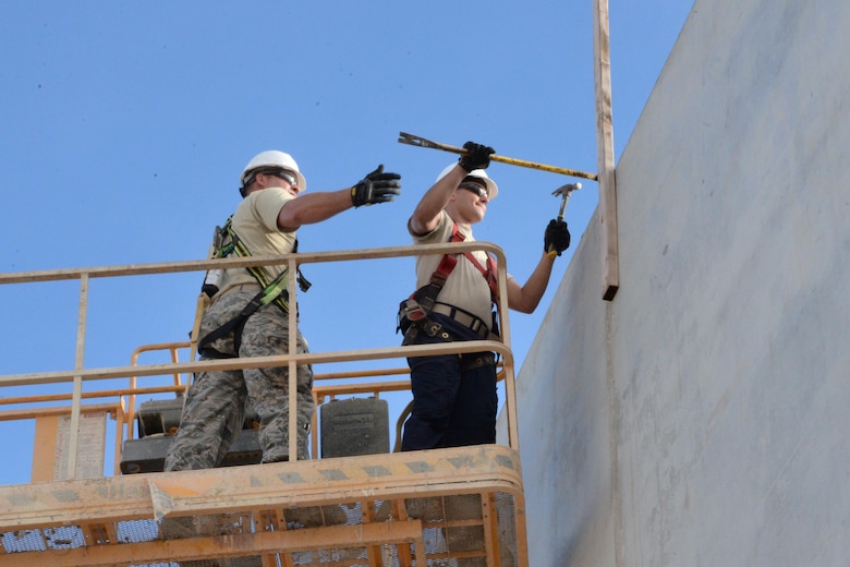 U.S. Air Force Airmen assigned to the 181st Intelligence Wing Civil Engineering Squadron, remove the safety line from the top of the building they are constructing during their annual training at Andersen AFB, Guam, July 14, 2016. The 181st engineers provided contingency related hands-on training for Air National Guard CE Airmen. (U.S. Air National Guard photo by Senior Airman Lonnie Wiram)