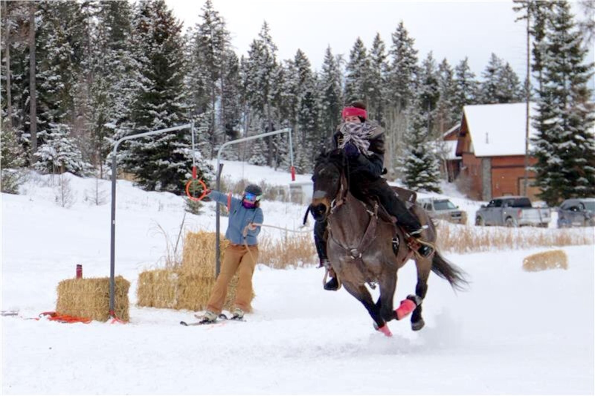 Air Force Office of Special Investigations Special Agent Katherine Licht and her horse, Storm, go Skijoring with a skier in Montana. Skijoring is like waterskiing behind a horse and is a winter outdoor equestrian sport in the western state. (Courtesy photo/SA Katherine Licht)   