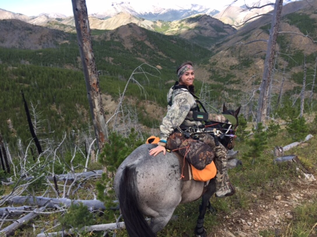 Air Force Office of Special Investigations Special Agent Katherine Licht, and her horse Storm, pause during a bow hunting trip in Montana's rugged terrain. (Courtesy photo/SA Katherine Licht)  