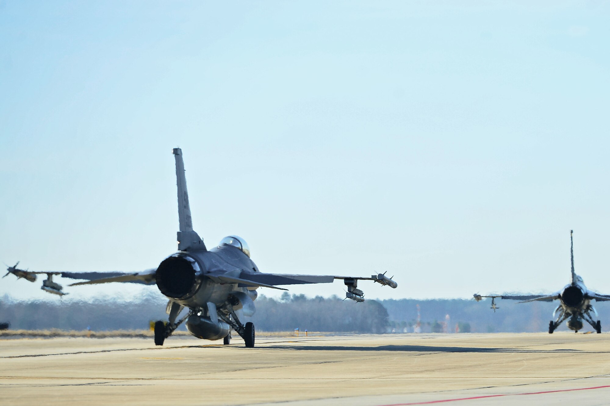 F-16CM Fighting Falcons assigned to the 55th Fighter Squadron taxi down the flightline during a surge at Shaw Air Force Base, S.C., Jan. 10, 2017. Surges are conducted by military installations to regain flying hours lost due to inclement weather or other unfavorable flying conditions. (U.S. Air Force photo by Airman 1st Class Christopher Maldonado)