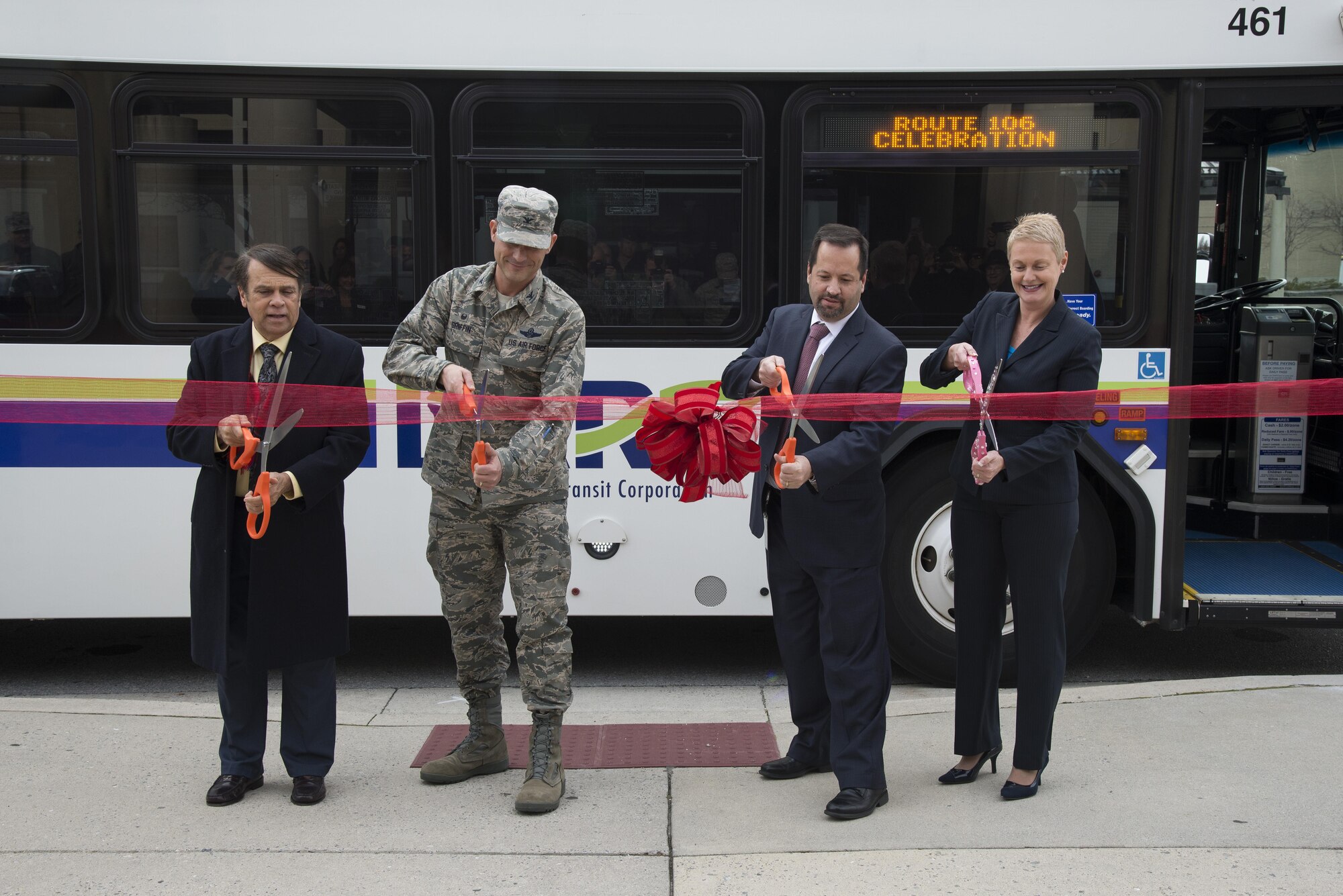 From left, Mayor of Dover Robin Christiansen; Col. Ethan Griffin, 436th Airlift Wing commander; John Sisson, Delaware Transit Corporation CEO; and Delaware Secretary of Transportation Jennifer Cohan prepare to cut a ribbon Jan. 5, 2016, outside Eagle’s Rest Inn on Dover Air Force Base, Del. The ceremony commemorated the grand opening of two new bus stops on base, which will better connect Airmen with the off-base community. (U.S. Air Force photo by Senior Airman Aaron J. Jenne)