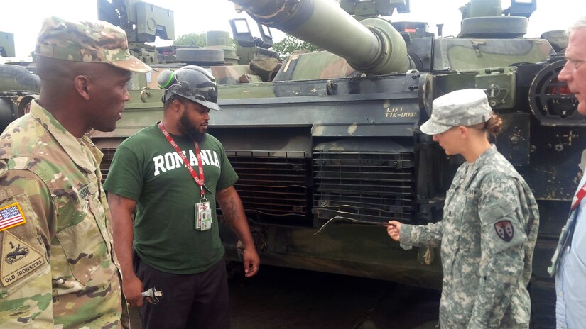 Staff Sgt. Danielle Milke, right, does a walk-through inspection of a M1A2 Abrams tank with AMC's Chief Warrant Officer 5 Darren Cook and a contract employee, Sept. 19 in Romania. The tanks were used during a U.S. Army Europe multinational training exercise. Milke volunteered to be the NCOIC for Army Prepositioned Stocks-Romania, and is a maintenance NCO for the Army Sustainment Command-Army Reserve Element, Detachment 12 from Fort Bragg, North Carolina. Cook is the Army Materiel Command command chief warrant officer at Redstone Arsenal, Alabama. (U.S. Army photo)