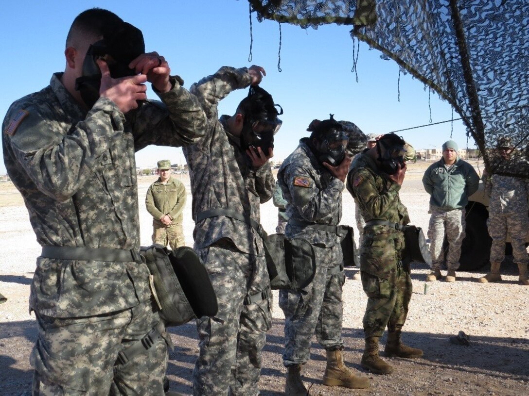 U.S. Army Reserve Soldiers from the 647th Regional Support Group, 4th Sustainment Command (Expeditionary), don their gas masks during a battle drill of react to a nuclear, biological and chemical attack to earn competitive points during the 647th RSG’s Best Warrior Competition on Fort Bliss, Texas, Jan. 6-8, 2017.  (U.S. Army Reserve photo by Maj. Amabilia G. Payen)
