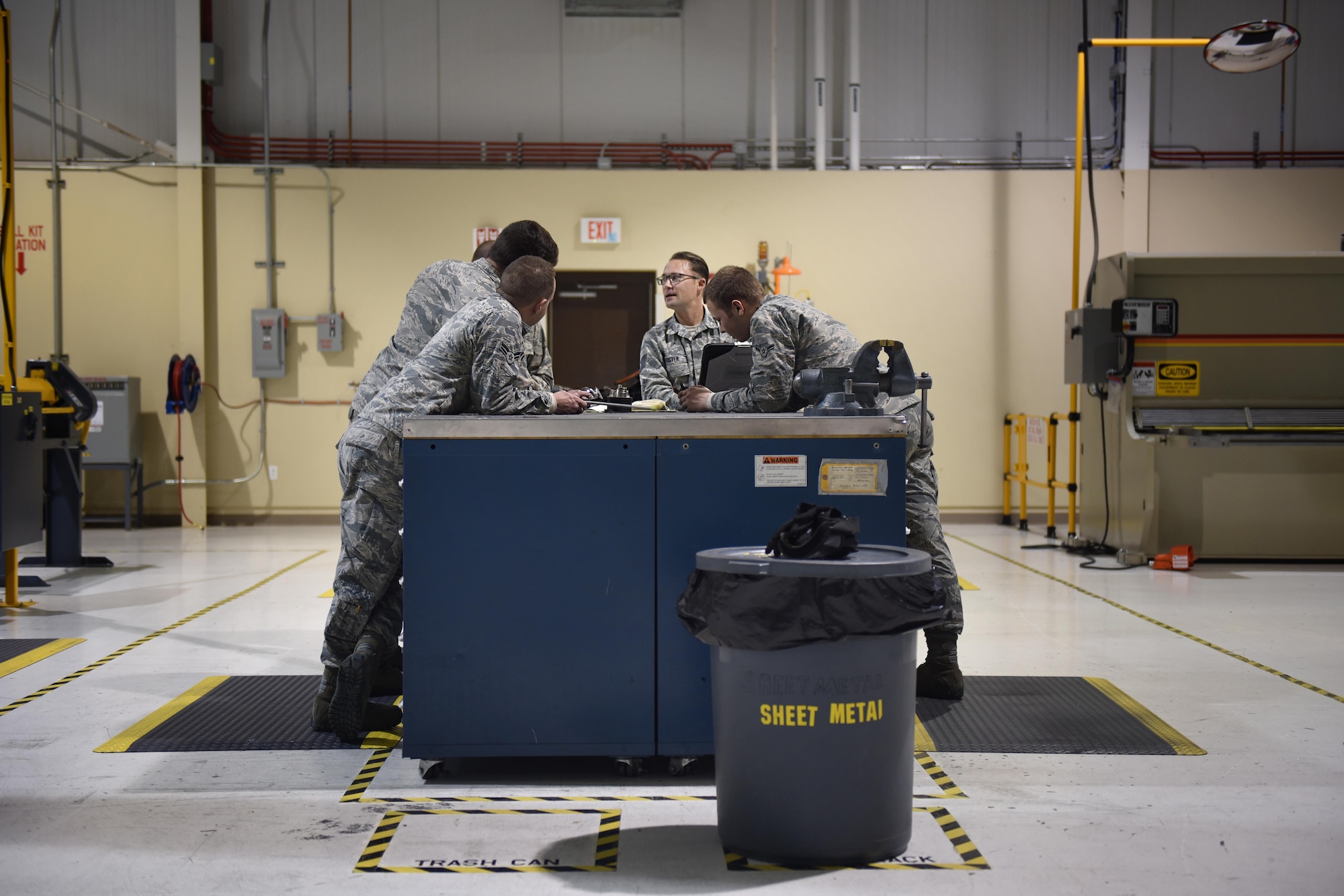 Aircraft Structural Maintenance apprentices with the 27th Special Operations Maintenance Squadron discuss a repair with Tech. Sgt. Matthew Foster, 27th Special Operations Maintenance Squadron Aircraft Structural Maintenance supervisor, November 16, 2016 at Cannon Air Force Base, N.M. Sheet metals technicians are part of a large group of Cannon Air Commandos who work through the night to keep aircraft flying. (U.S. Air Force Photo by Senior Airman Shelby Kay-Fantozzi/released) 