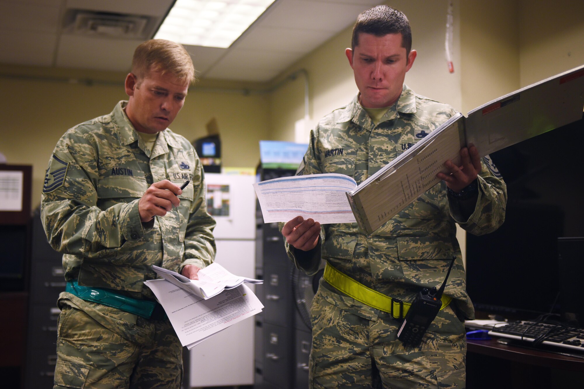 U.S. Air Force Master Sgts. Gabriel Austin, 27th Special Operations Aircraft Maintenance Squadron CV-22 production superintendent, and Christian Martin, 27th Special Operations Maintenance Squadron production superintendent, coordinate a full night’s to-do list November 16, 2016 at Cannon Air Force Base, N.M. Production superintendents task out the night’s repairs and bridge between the multiple shops working through the night to get the job done. (U.S. Air Force Photo by Senior Airman Shelby Kay-Fantozzi/released)